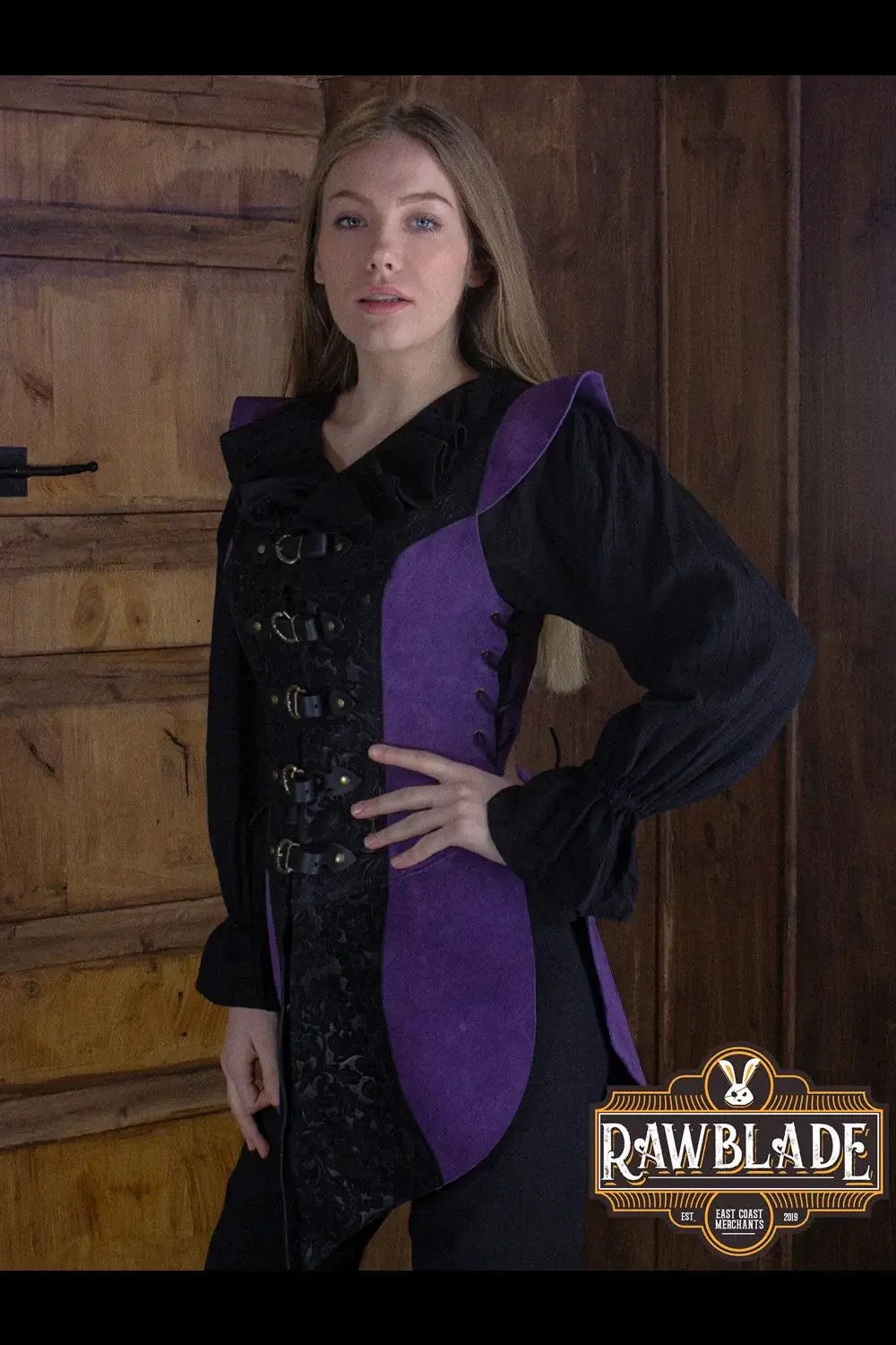 Model showcasing the Ylenne Deluxe Long Doublet with embossed leather and hand riveted buckles, in a rustic setting.