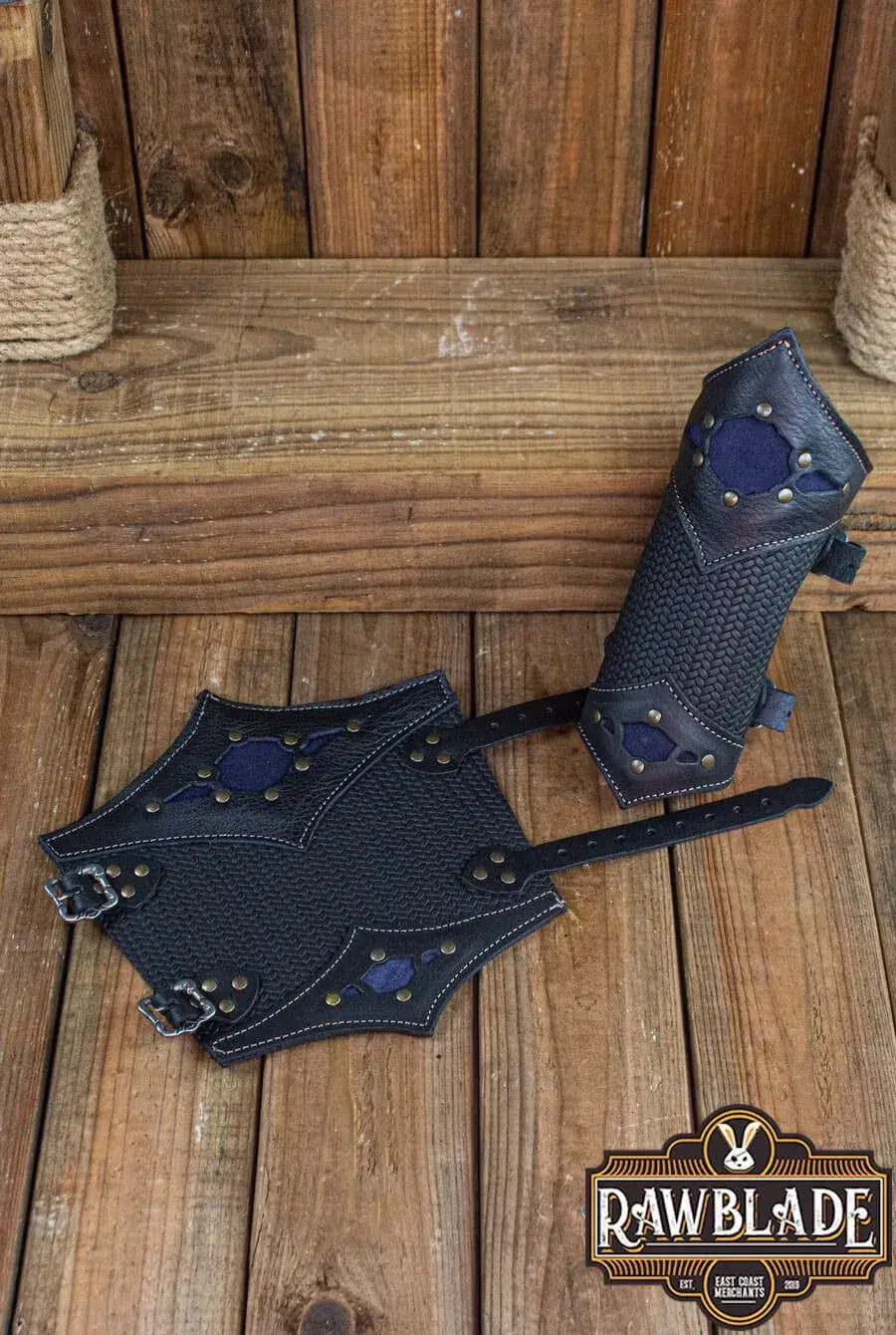 Beljant Bracer, ultra-resistant leather bracers with decorative diamond and buckles, displayed on wooden surface.