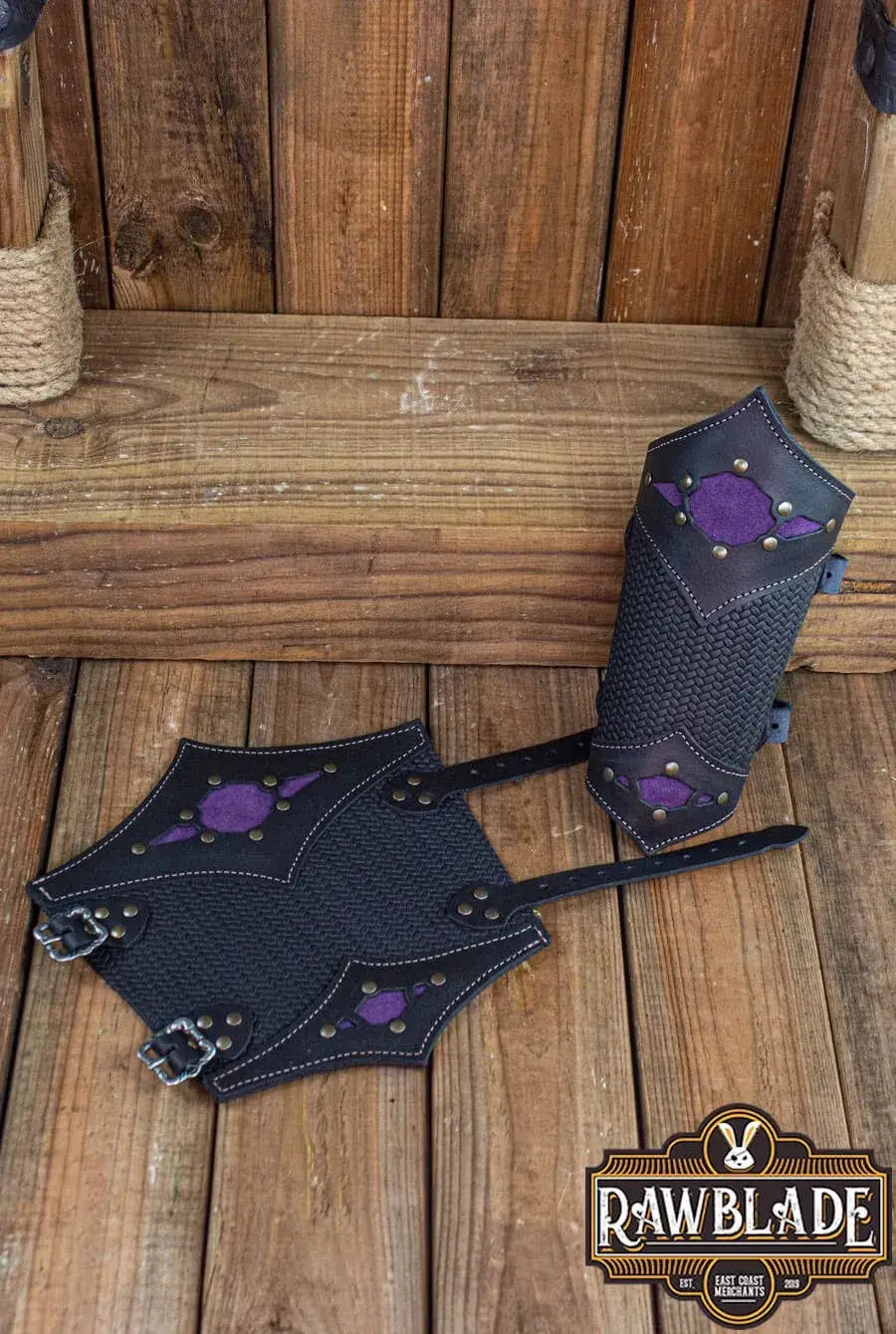 Beljant Bracer pair with purple diamond accents on a wooden background, showcasing durable leather craftsmanship.