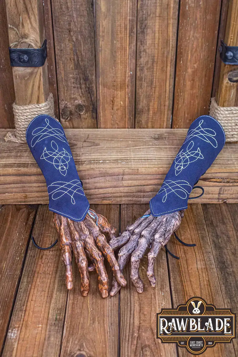 Vryla Premium Bracers displayed on wooden background, showcasing lightweight leather design and elven style.