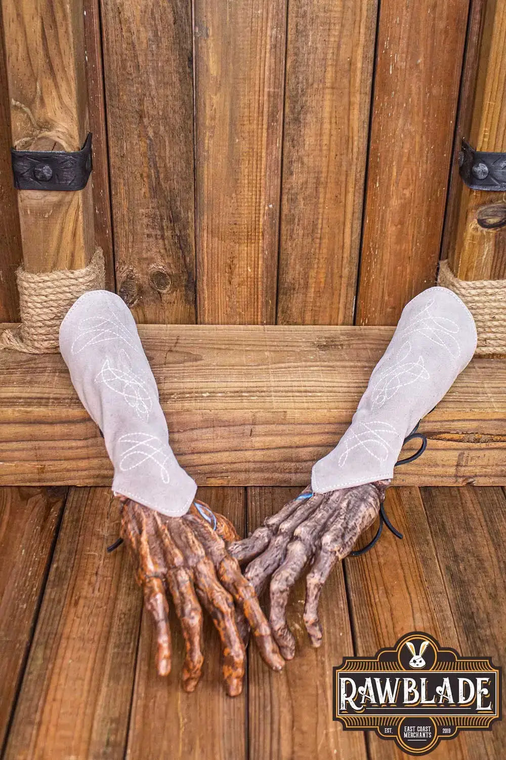 Vryla Premium Bracers displayed on wooden background with intricate designs and unique elven style.