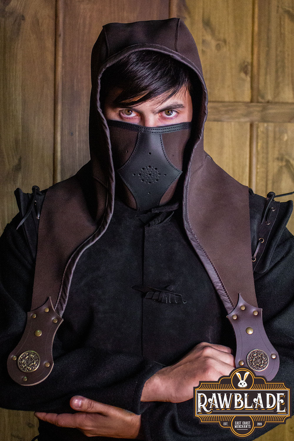 Person wearing Akku Splitleather Hood with mask, showcasing leather reinforcements and stylish design.