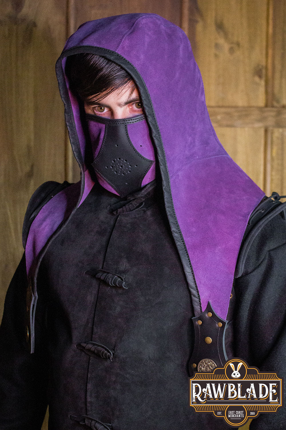 A model wearing the Akku Splitleather Hood with a mask, showcasing its unique style and elegant design.