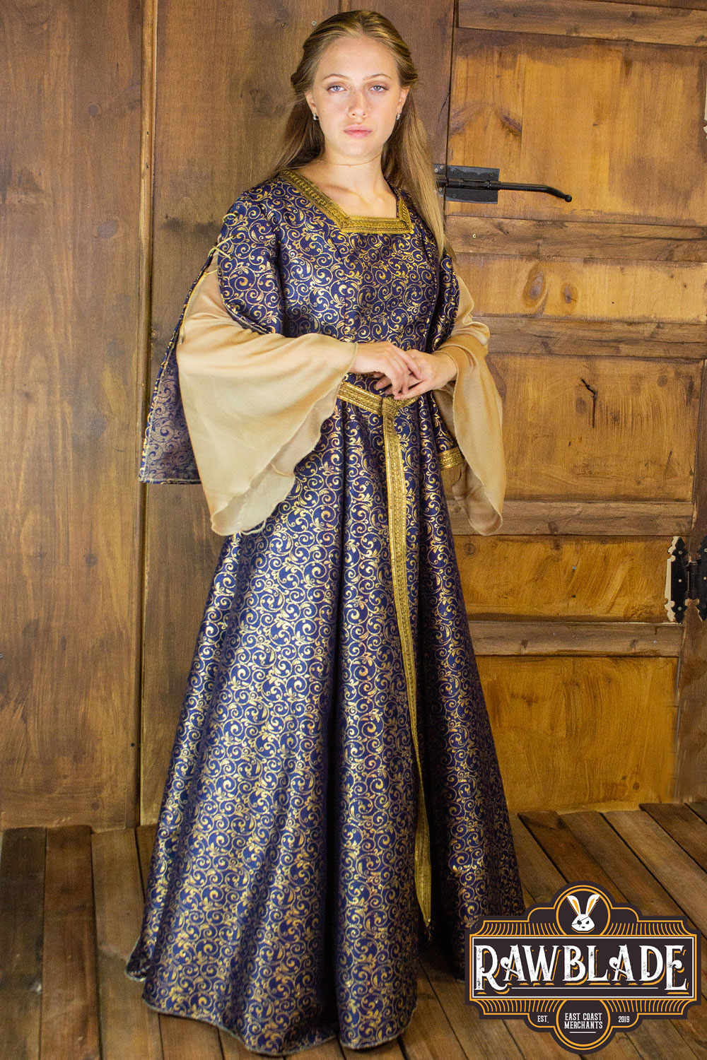 Aquitania Noble Dress showcased on a model, featuring gold brocade fabric and double tulle sleeves.