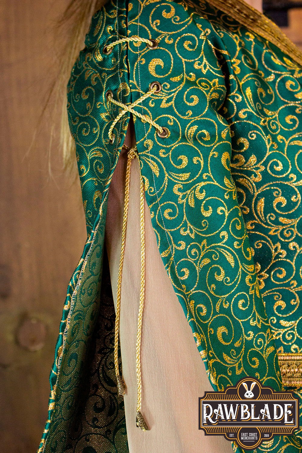 Detail of the Aquitania Noble Dress showing gold trims and laces on the elegant sleeves.
