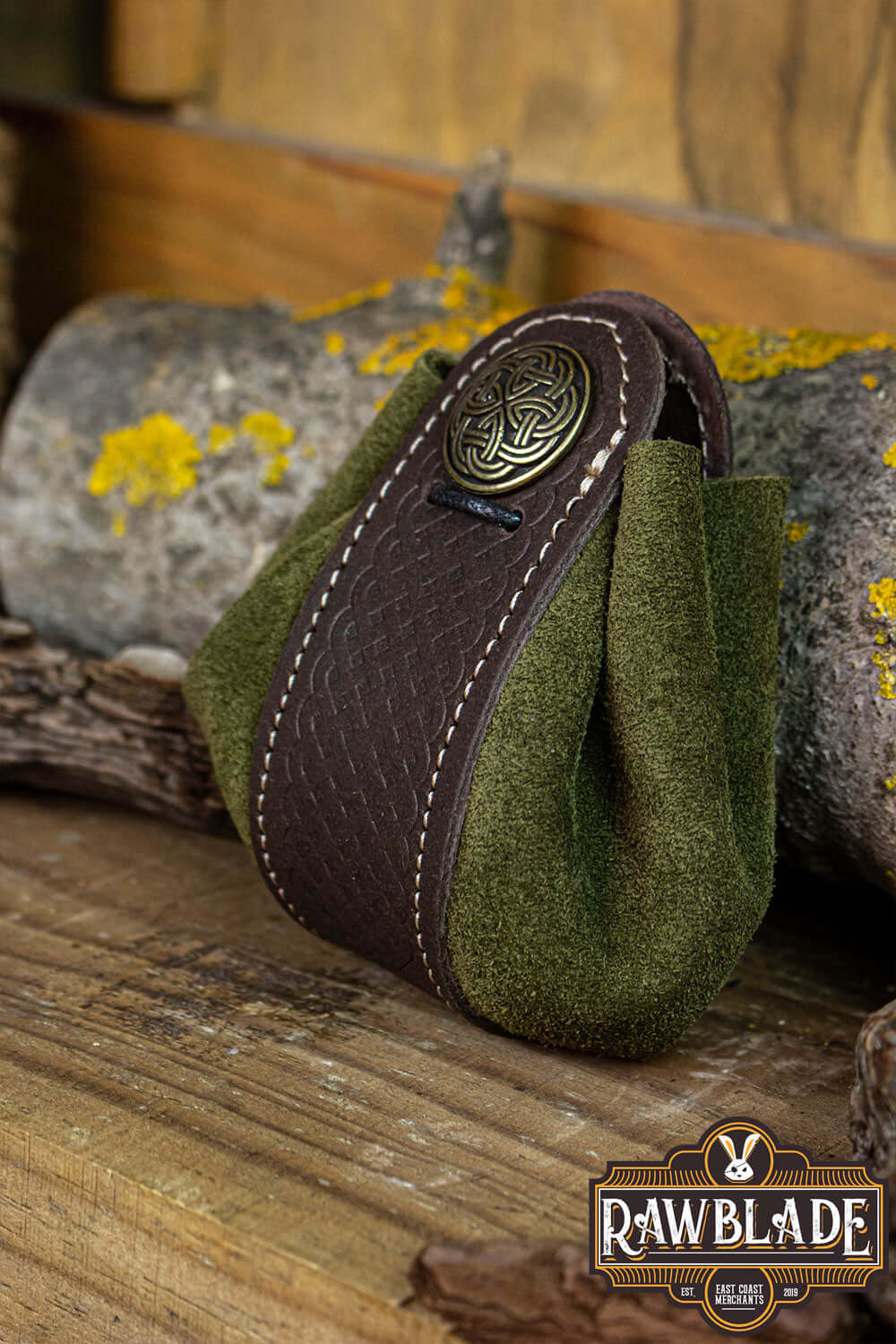 Wanderer Pouch Big in green and brown split-leather with Celtic metal trimmings on wood background.