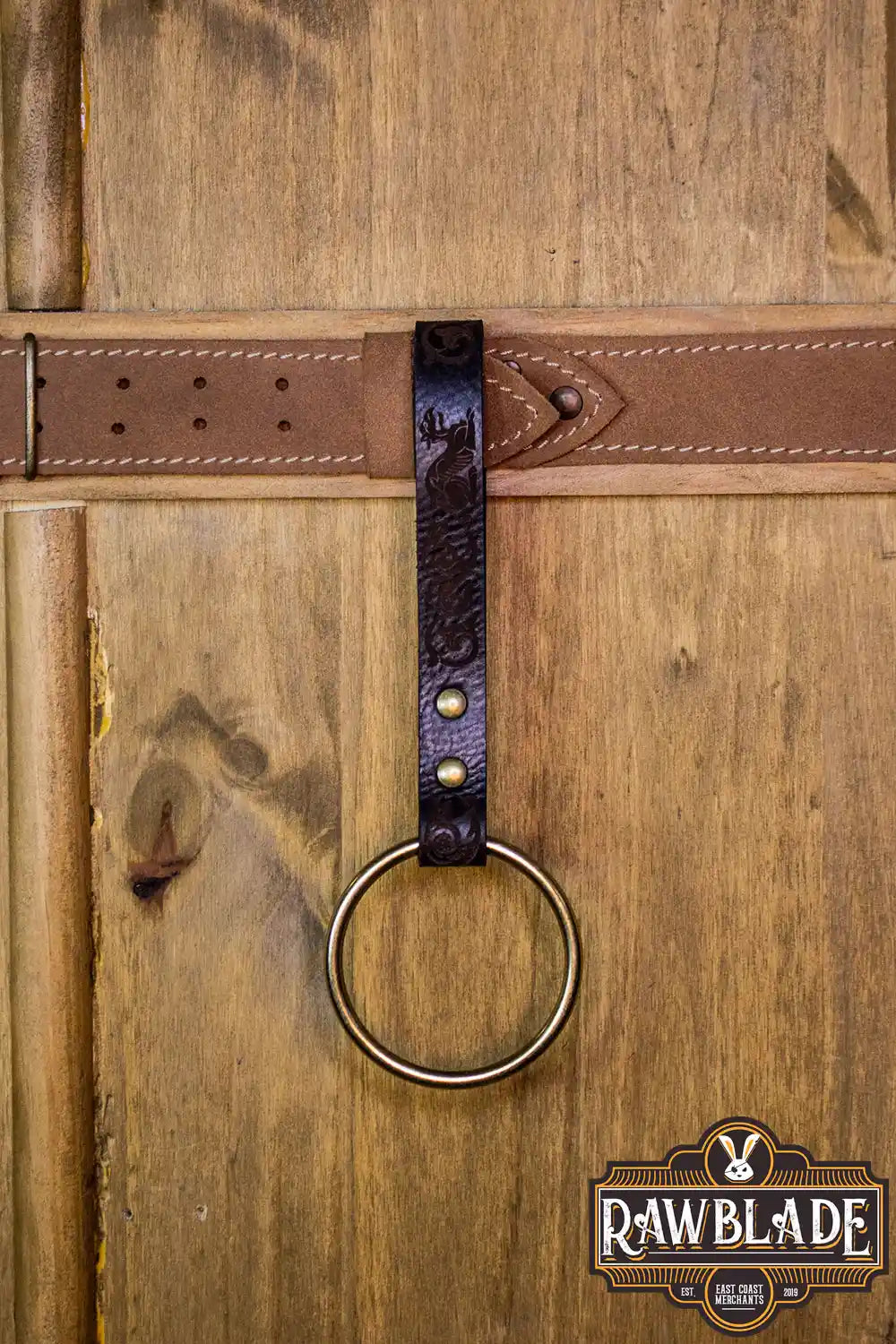 Aquitania Ring Holder attached to a belt, showcasing its ornate engraving and sturdy design.