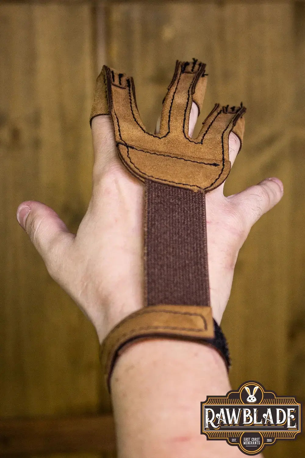 Archery Glove Kane worn on hand showing three finger design and adjustable velcro strap.