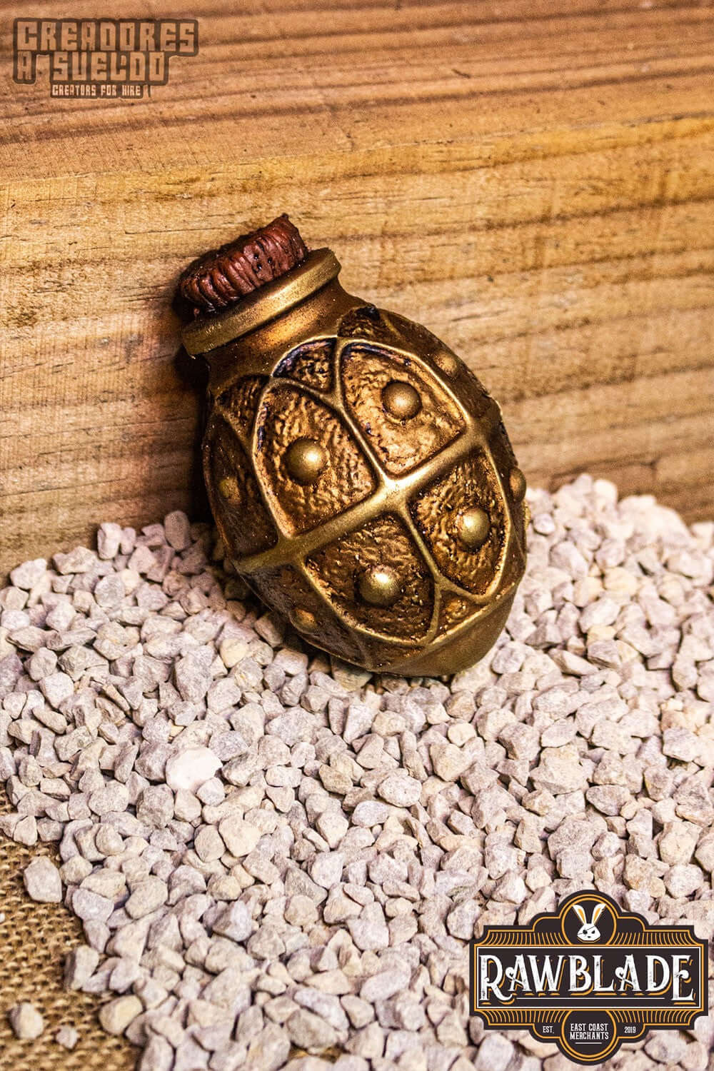 Alchemical Crock from Rawblade, a flexible foam throwing weapon, designed for mages and alchemists, on gravel background.